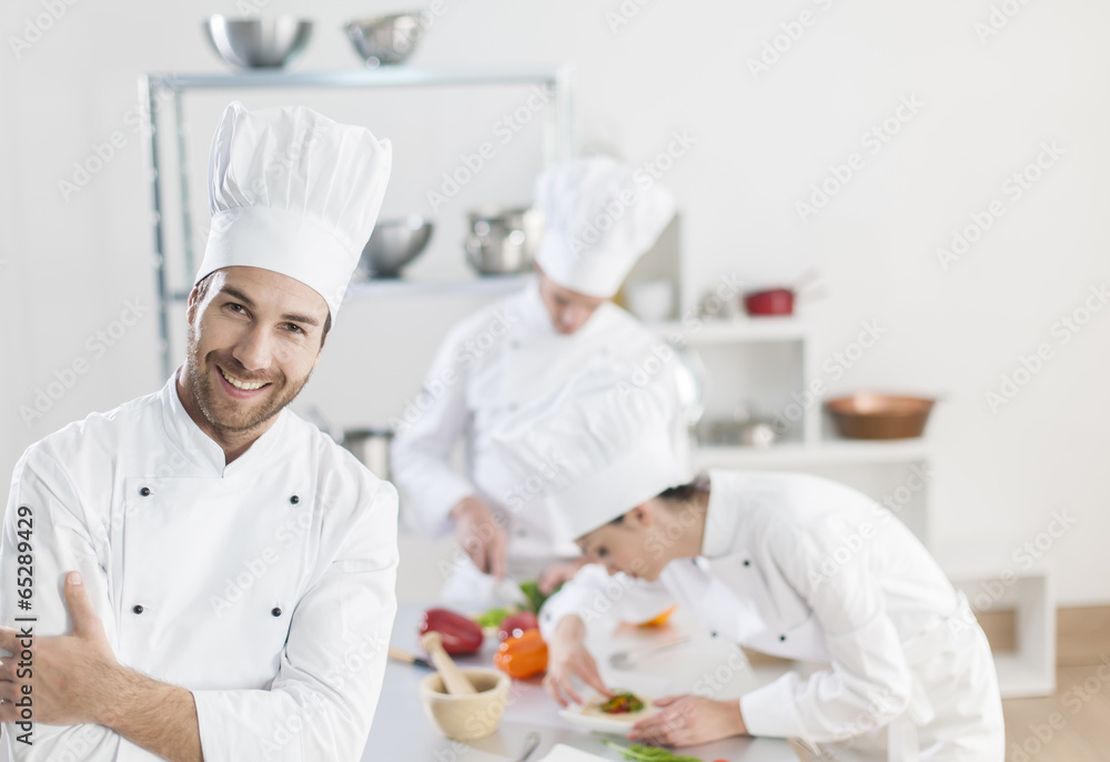 kitchen team at work chef at foreground