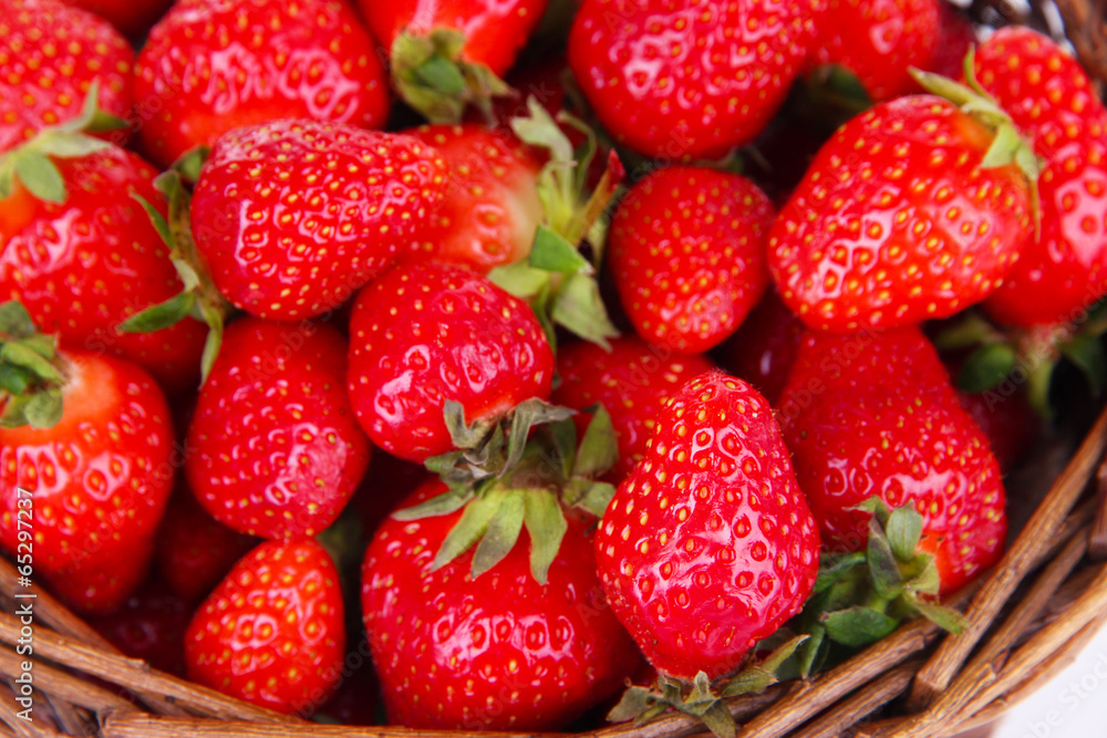 Ripe sweet strawberries in wicker basket, close-up Ripe sweet strawberries in wicker basket, close-up