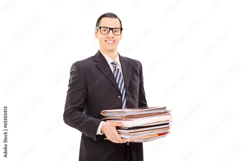 Smiling businessman holding a stack of documents Smiling businessman holding a stack of documents