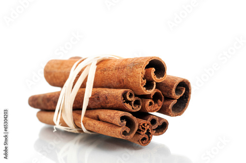 Tied cinnamon sticks isolated on white background