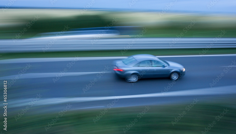 Fast going car on the highway, motion blurred Fast going car on the highway, motion blurred