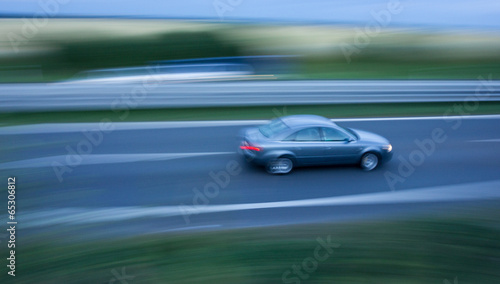 Fast going car on the highway, motion blurred