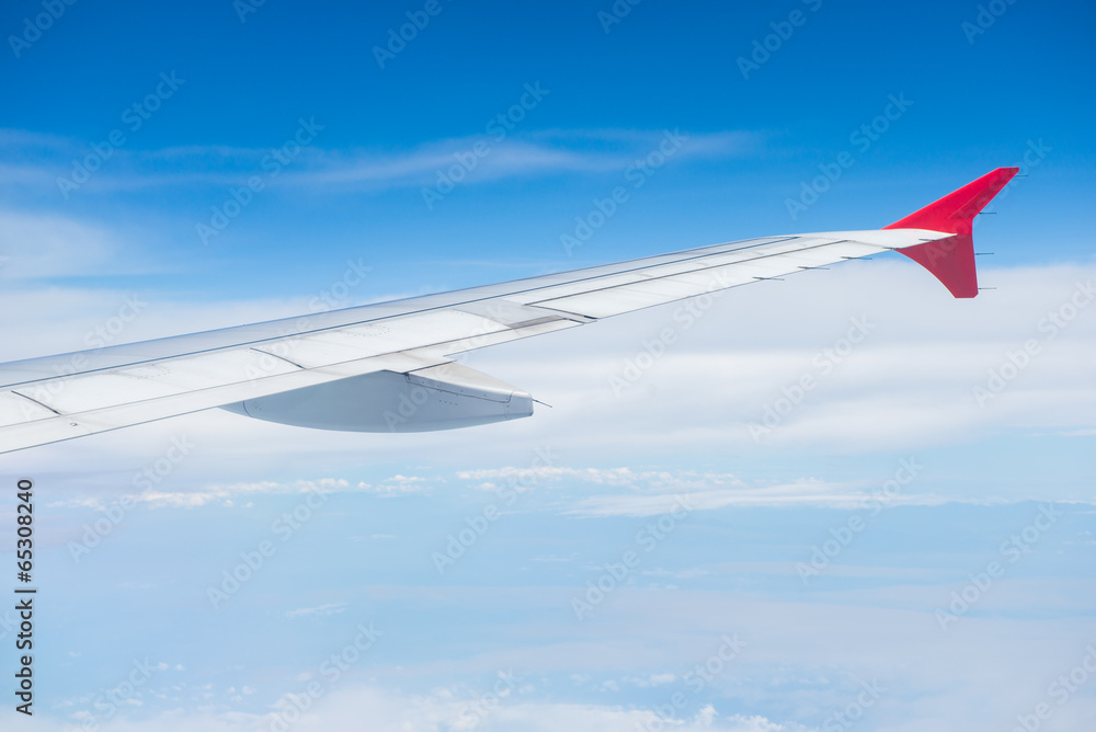 Fototapeta premium Wing of an airplane flying in the sky