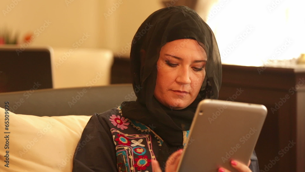 Muslim woman using digital tablet Muslim woman using digital tablet