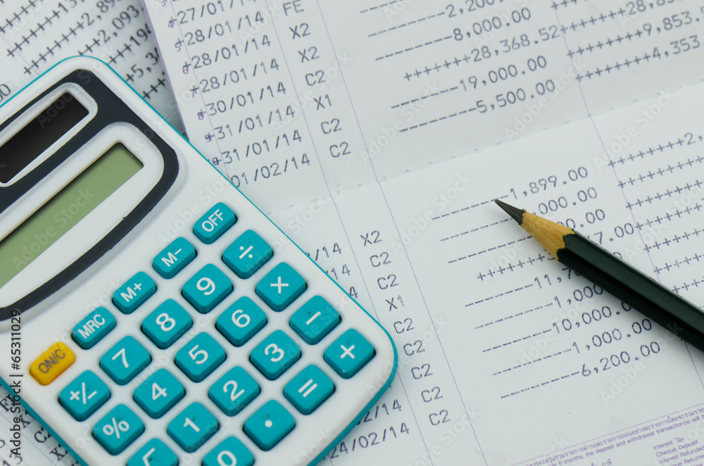 close up bank statement with calculator close up bank statement with calculator