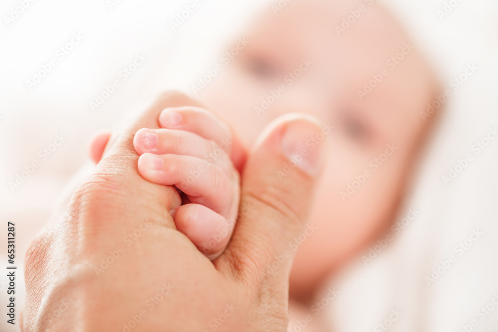 Concept of love and family. hands of father and baby closeup Concept of love and family. hands of father and baby closeup