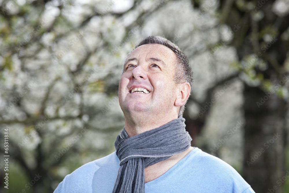 Friendly man in nature under blooming cherry tree Friendly man in nature under blooming cherry tree