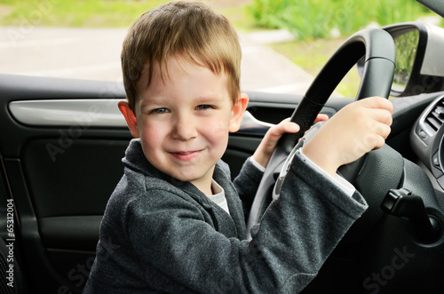 smiling boy driving horizontal photo