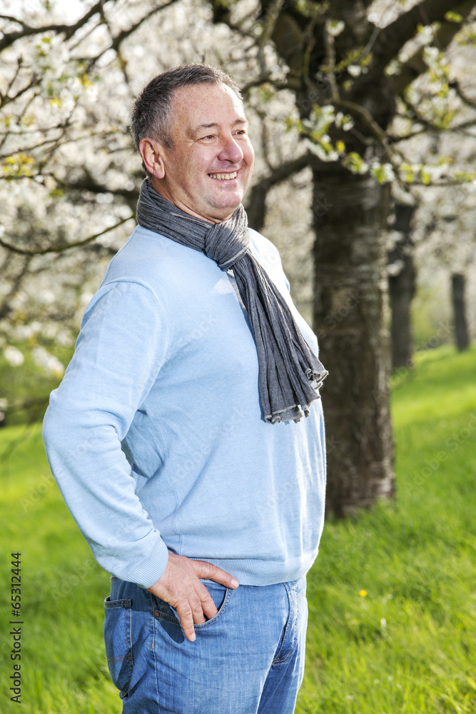 Friendly man in nature under blooming cherry tree Friendly man in nature under blooming cherry tree
