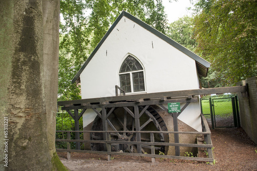 Watermill with paddle wheel in forest