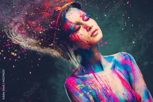 Young woman muse with creative body art and hairdo