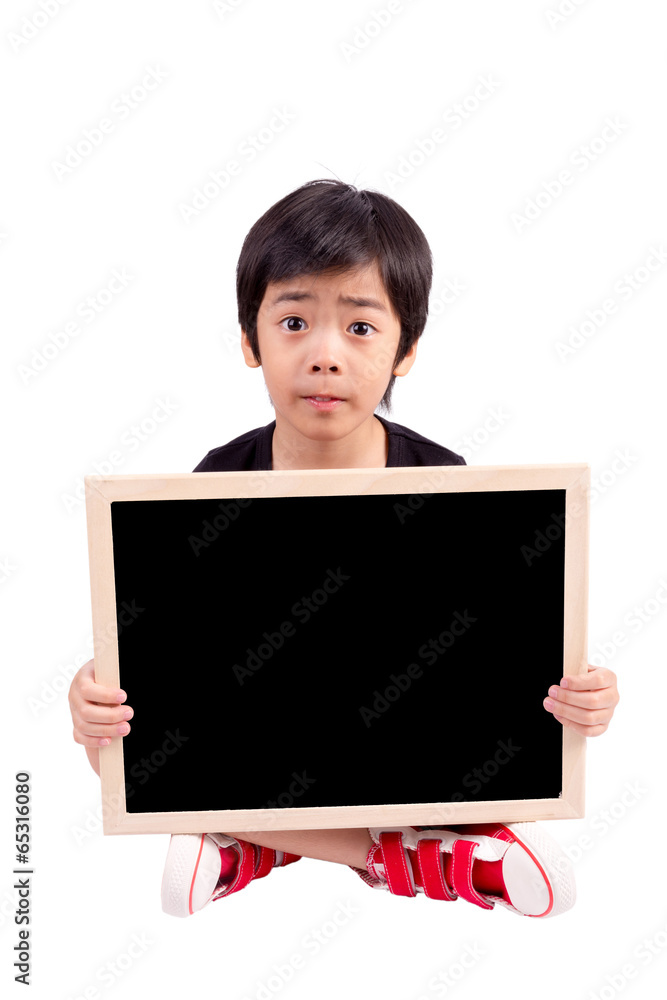 Portrait of a surprised little boy holding a billboard against w Portrait of a surprised little boy holding a billboard against w