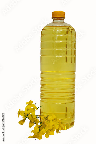 plastic bottle of rape seed oil with rape flowers