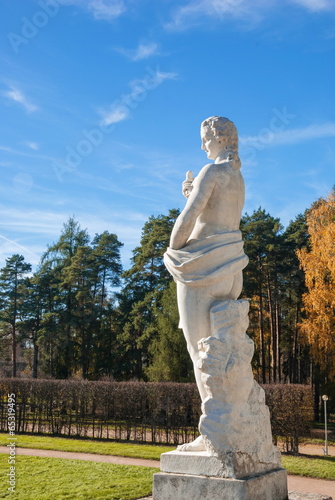 Antique sculpture in background of  autumn Park photo