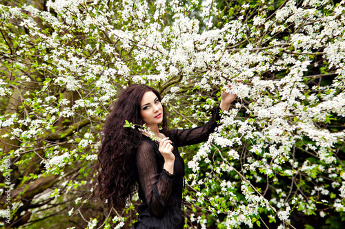 Young woman and blossom tree