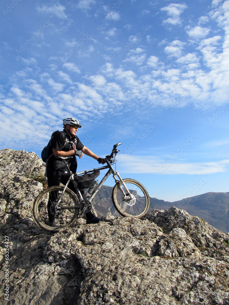 Fototapeta premium Cyclist Riding the Bike on the Beautiful Spring Mountain Trail