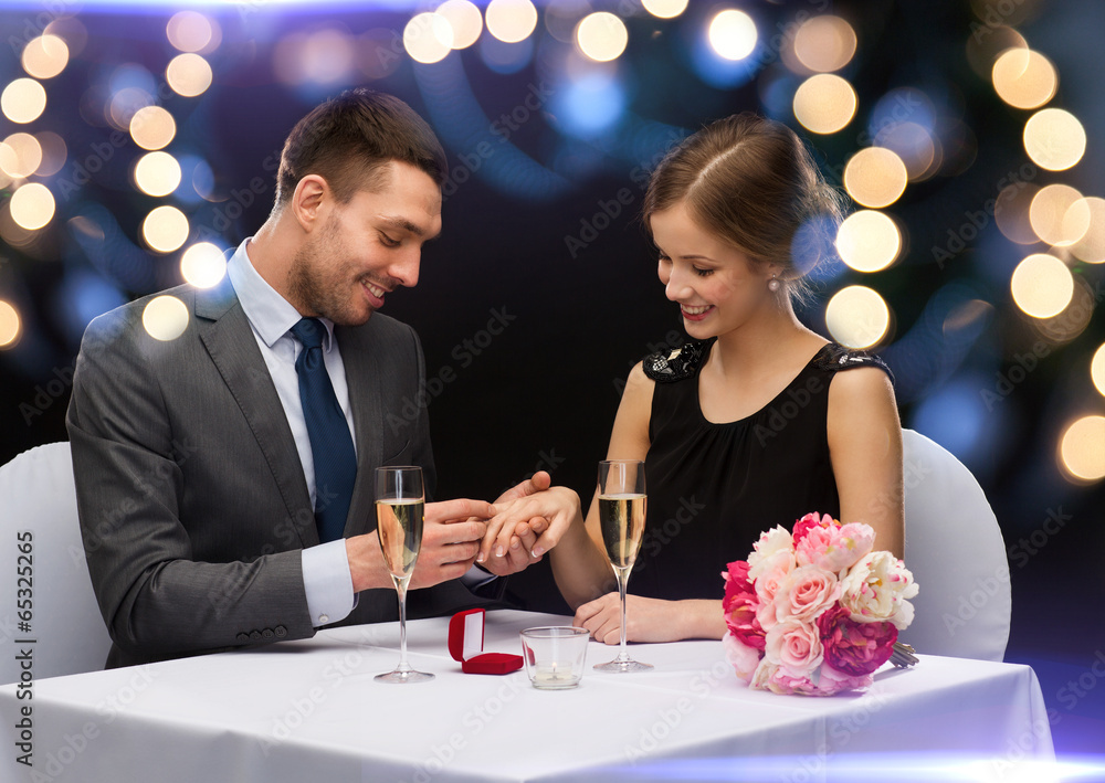 man proposing to his girlfriend at restaurant man proposing to his girlfriend at restaurant