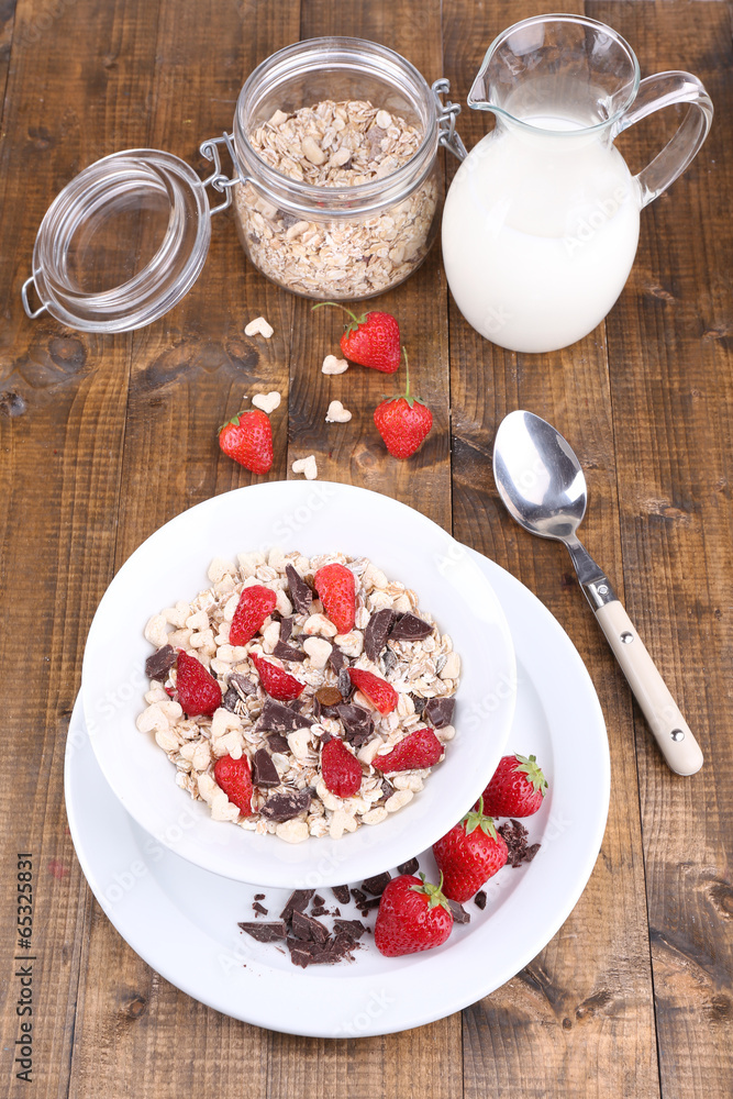 Healthy cereal in bowl with strawberries and chocolate