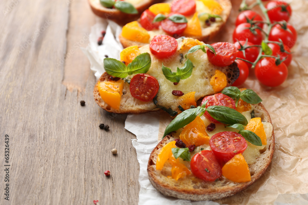 Tasty bruschetta with tomatoes, on old wooden table Tasty bruschetta with tomatoes, on old wooden table