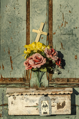 Rustic old doorway flowers and cross photo