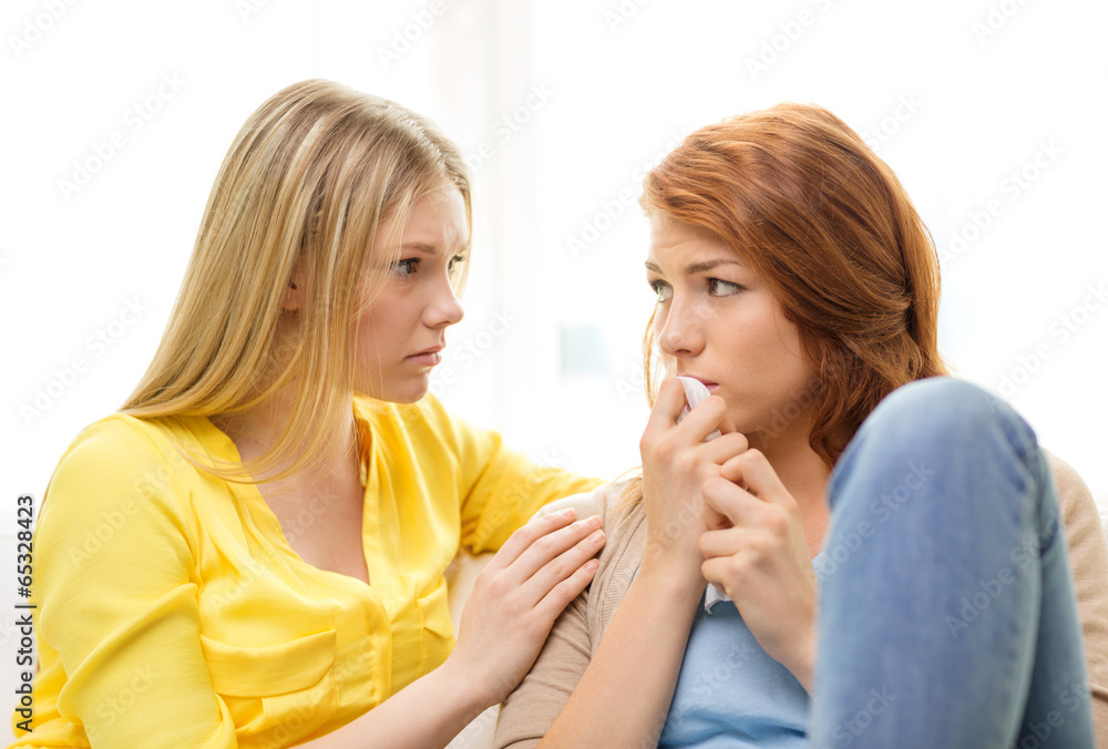 one teenage girl comforting another after break up one teenage girl comforting another after break up