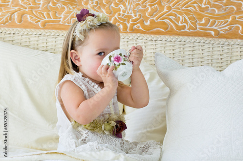 Little girl playing tea party