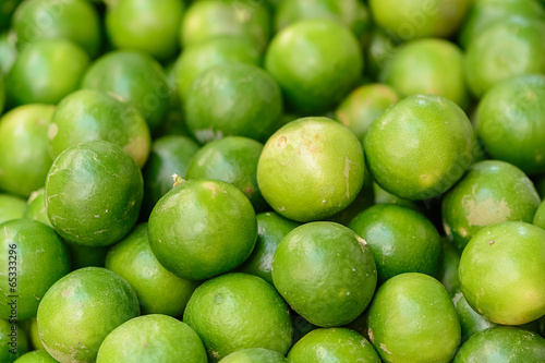 fresh green lemon asia in the market , background blur