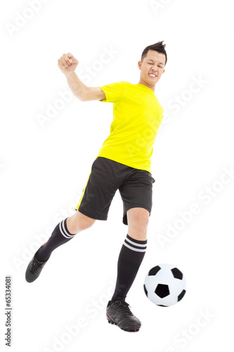 Soccer player kicking ball © Tom Wang