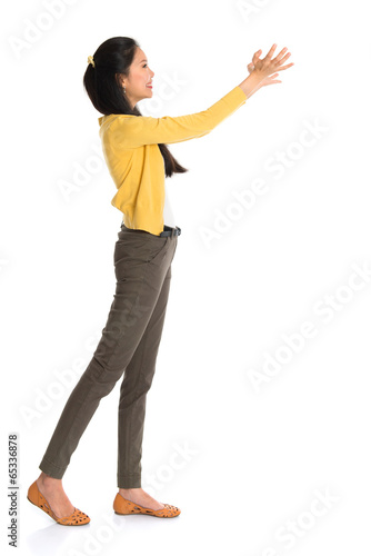 Asian woman holding something