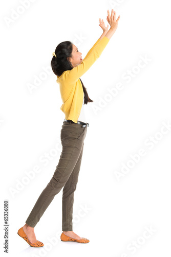 Asian woman pushing something