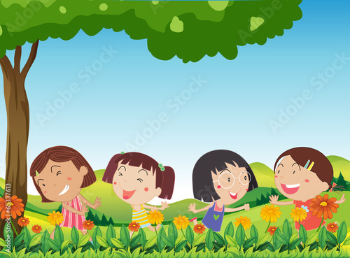 Happy kids playing outdoor near the blooming flowers