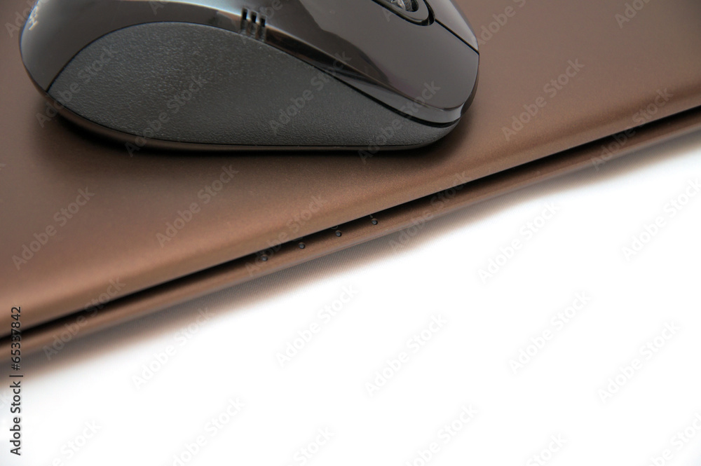 Bluetooth black mouse on the chocolate laptop Bluetooth black mouse on the chocolate laptop