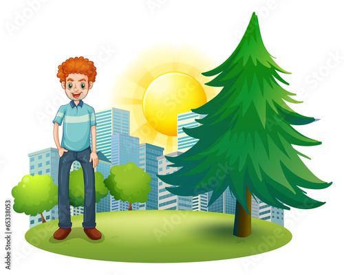 A smiling man standing beside the pine tree
