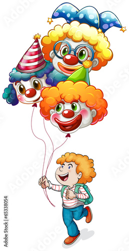 A happy young man holding clown balloons