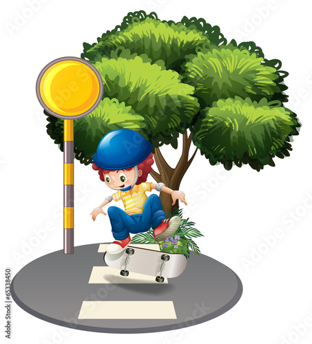 A young boy skating at the road
