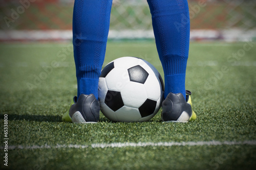 Soccer player's feet on the ball