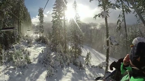 snowboarders on a chairlift of ski resort Bansko photo