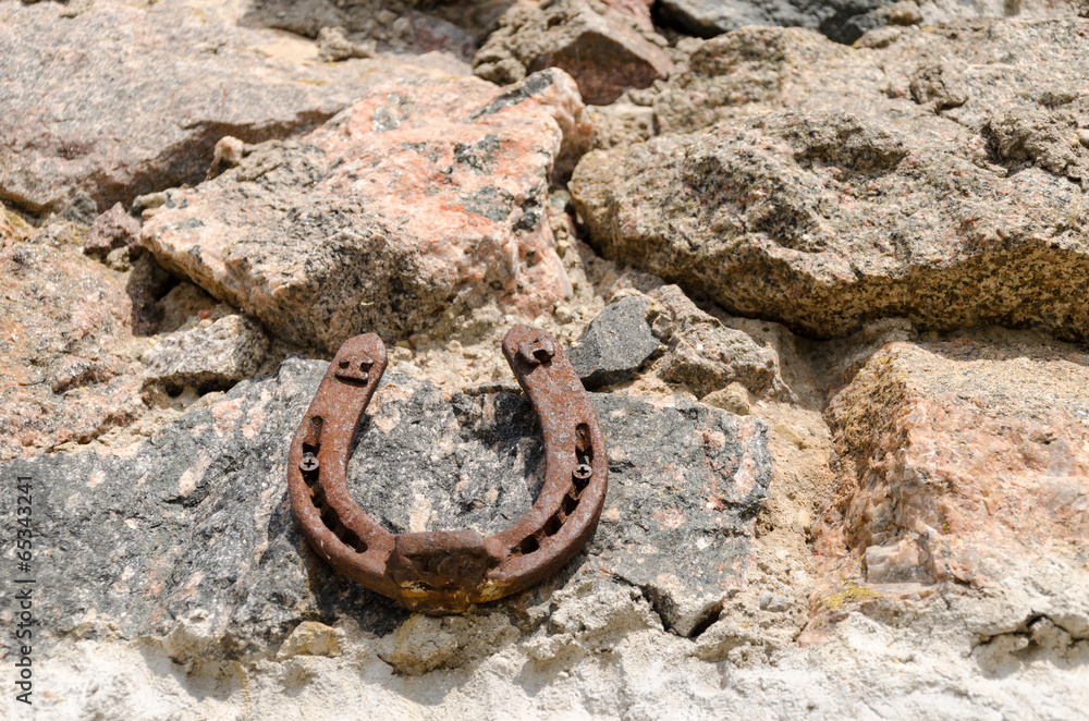 old iron fortune symbol horseshoe on stone wall old iron fortune symbol horseshoe on stone wall