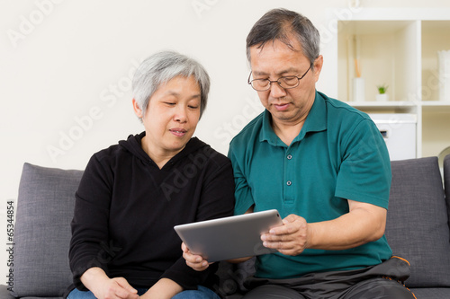 Senior couple using their tablet © leungchopan