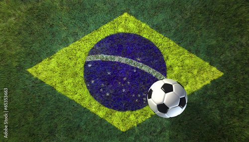 Soccer ball on grass  with Brazilian flag