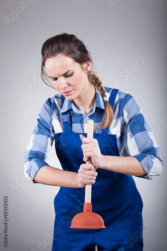 Woman using a plunger photo