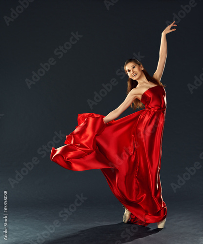 beautiful ballerina dancing a long red dress flying