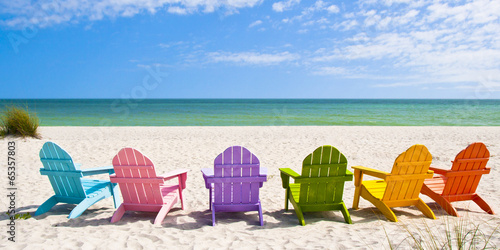 Slika na platnu Adirondack Beach Chairs on a Sun Beach in front of a Holiday Vac