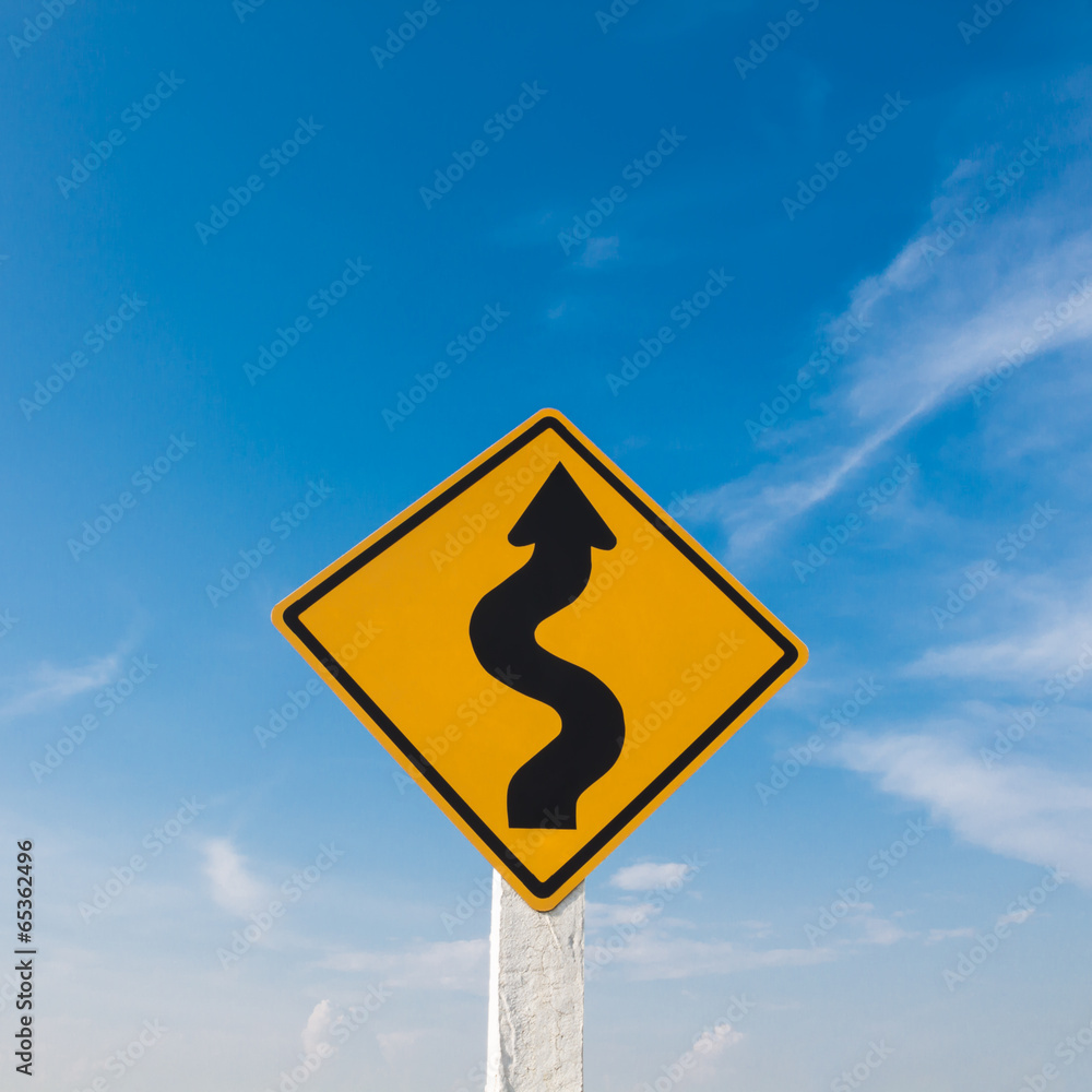Winding road sign with a blue sky. Winding road sign with a blue sky.