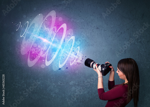 Photographer girl making photos with powerful light beam