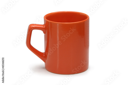 Orange ceramic mug isolated on white background.