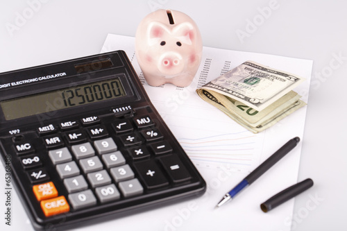 Business Charts with calculator, money, piggy box and pen