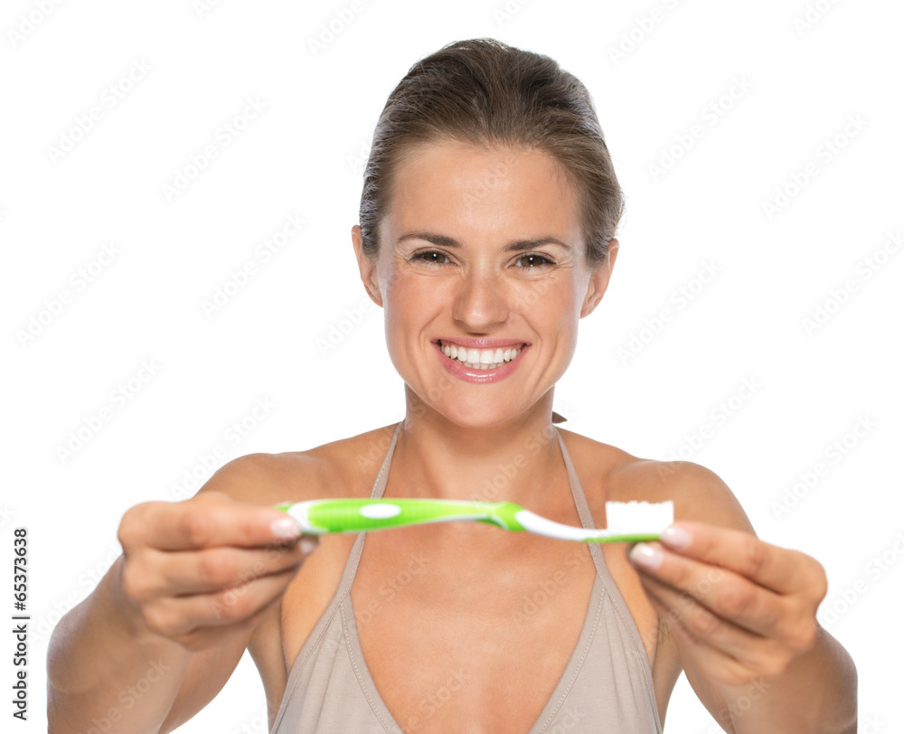 Portrait of happy young woman showing toothbrush Portrait of happy young woman showing toothbrush