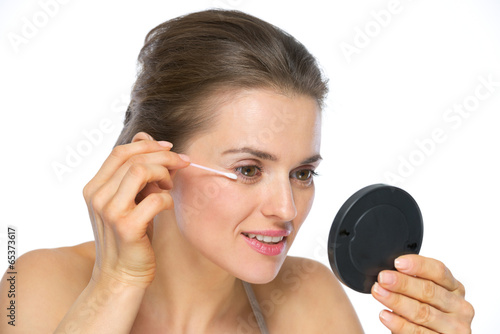 Young woman using cotton swabs