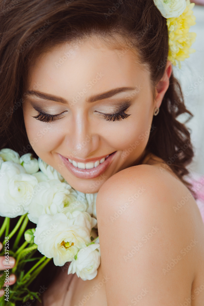 Portrait of Beautiful Young Woman in Flowers. Healthy Long Hair Portrait of Beautiful Young Woman in Flowers. Healthy Long Hair